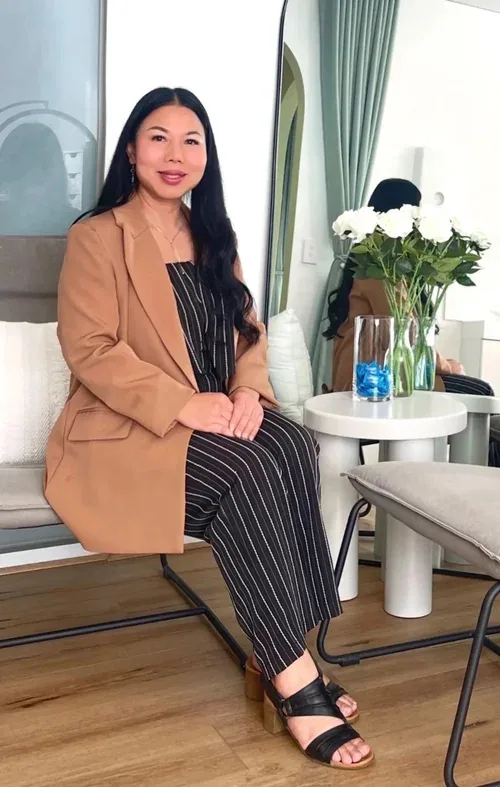 Cherry, owner of Adore Lash & Brow Co, seated in the studio
